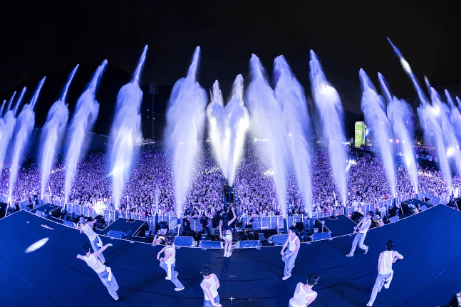 The Water Bomb festival scene, symbolizing summer festivals, with relentless water showers pouring down.