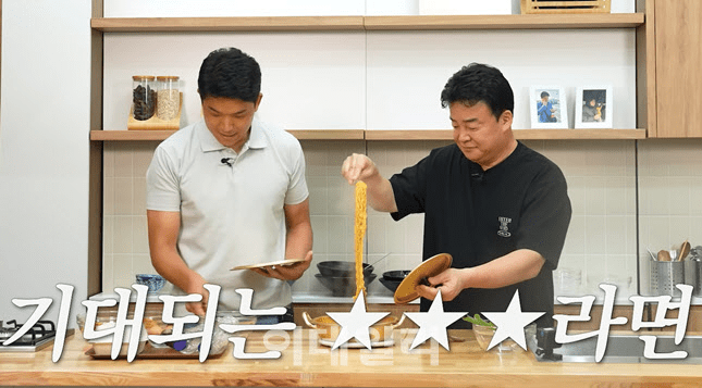 (From left) Chef Ahn Sung-jae and Jongwon Paik, CEO of The Born Korea. Chef Ahn is introducing his garlic ramen recipe on Paik’s YouTube channel.